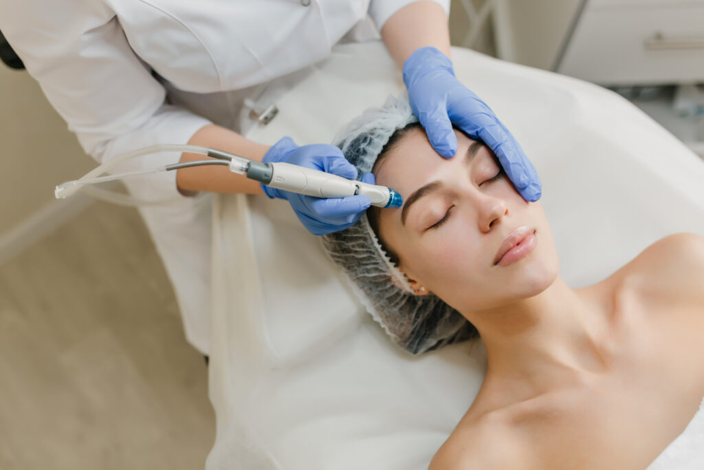 Woman receiving Hydrafacial treatment in Navi Mumbai at Bodyskulpt Aesthetics clinic for glowing and hydrated skin.